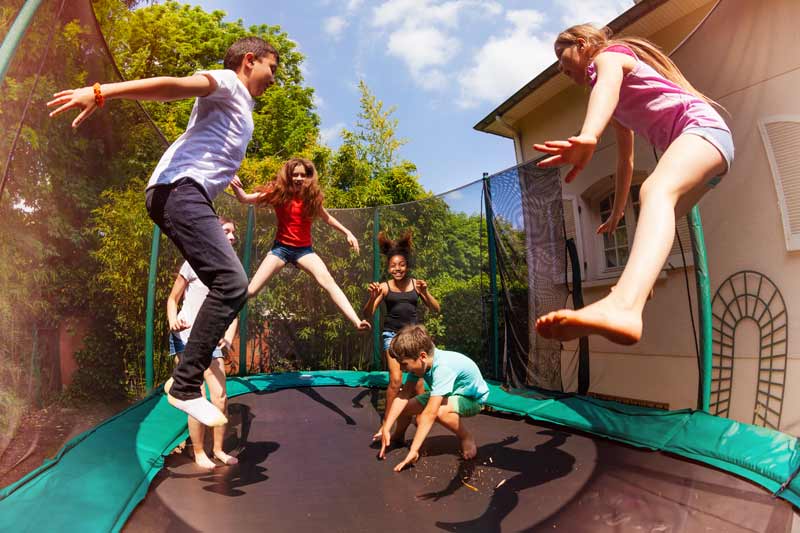 multiple children jumping on the same trampoline