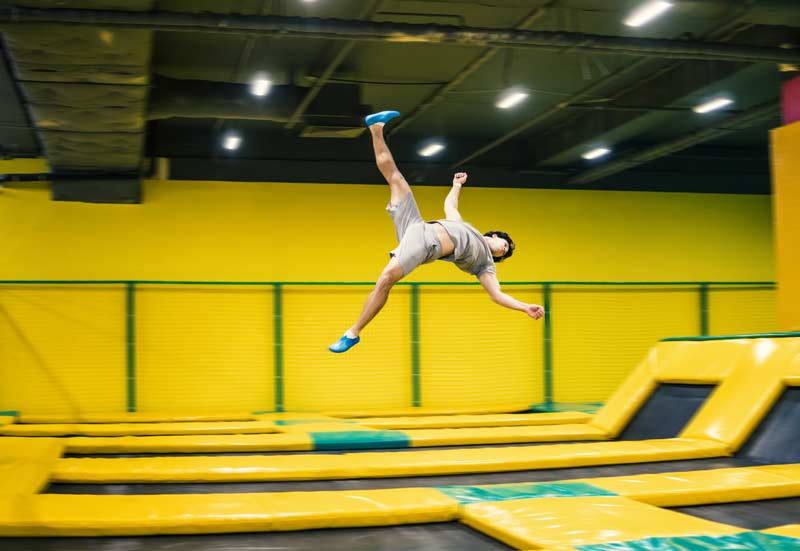 trampoline jumper performs complex aeorobatic exercises and somersaults
