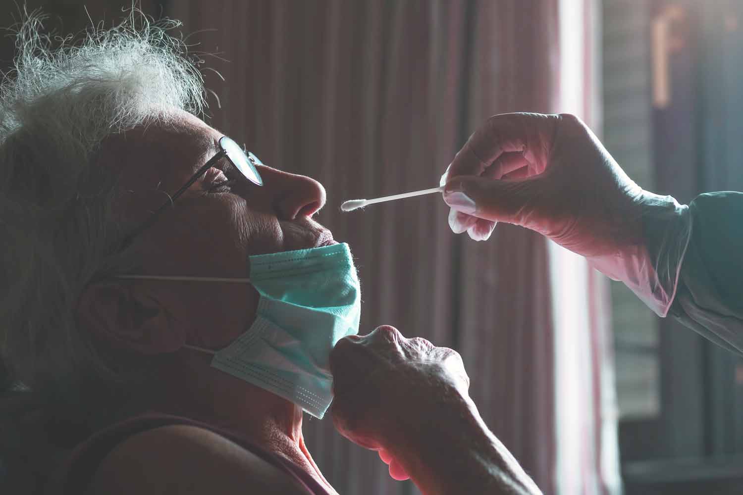 COVID-19 swab nose test performed on elderly woman