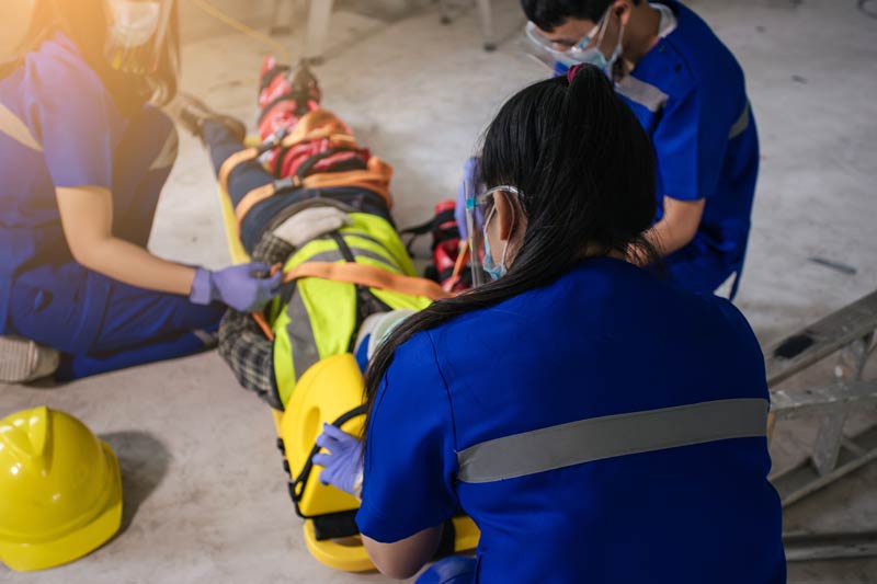 paramedic and team first aid for builder accident