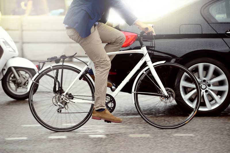 bicycle rider cycling in traffic