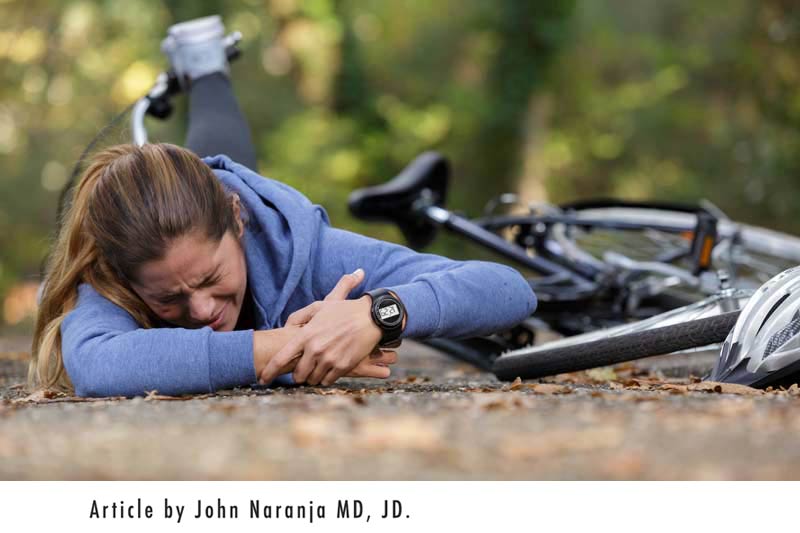 woman fell off bicycle on the ground - common accidents bicycling