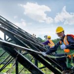 construction workers wearing safety harness protecting against fall