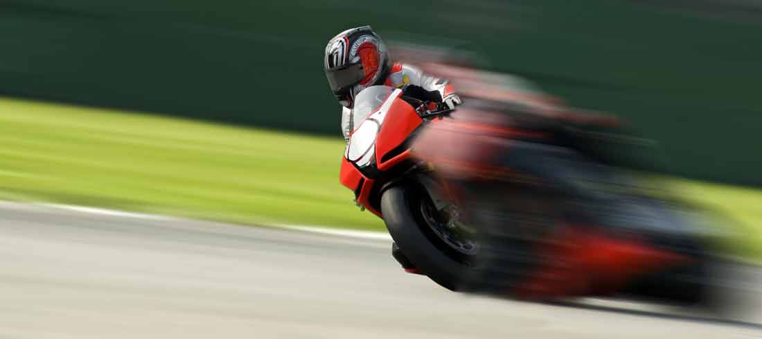 motorcycle driver racing at high speed