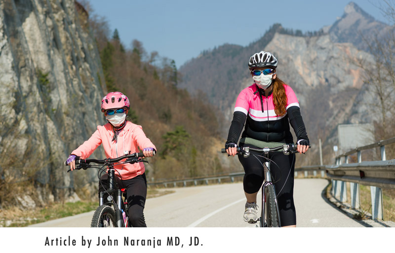 mother and daughter bicycling down a mountan road