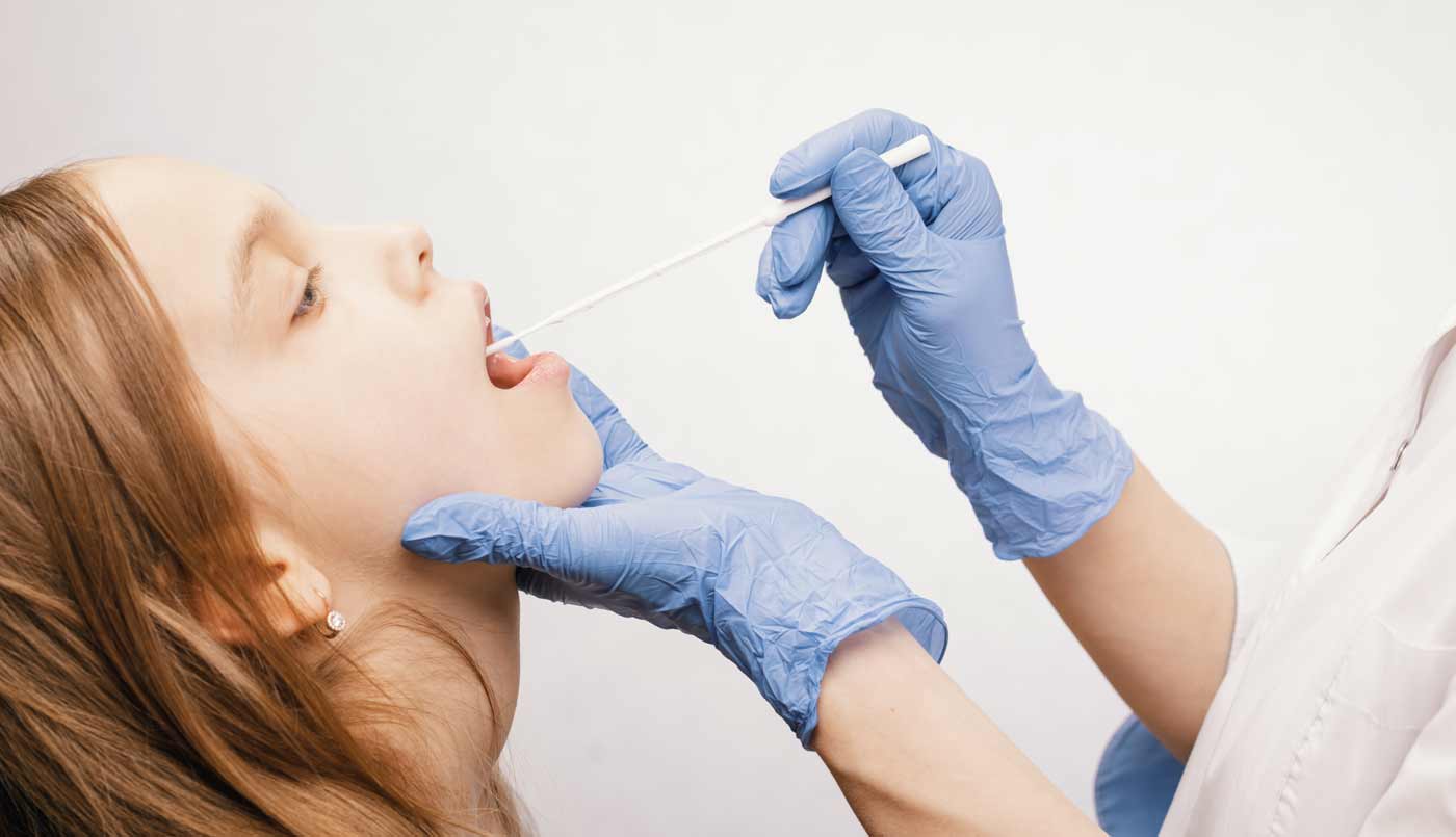 pediatrician taking saliva test sample