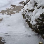 snow on steps and sidewalk looking out an open door
