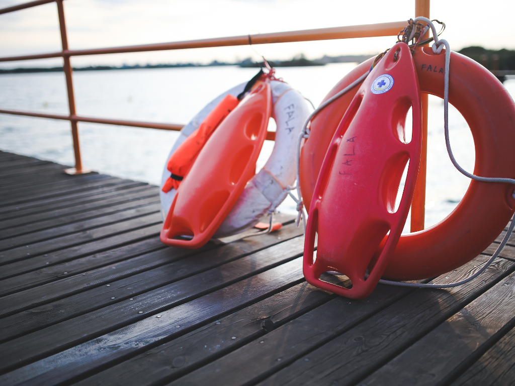 Life rings and rescue buoys on a dock beside the water