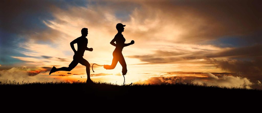 woman runs with prothesis - man running behind