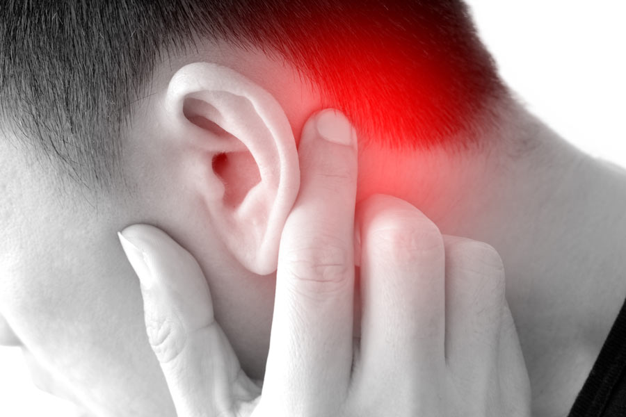 young man touching_painful area behind his ear